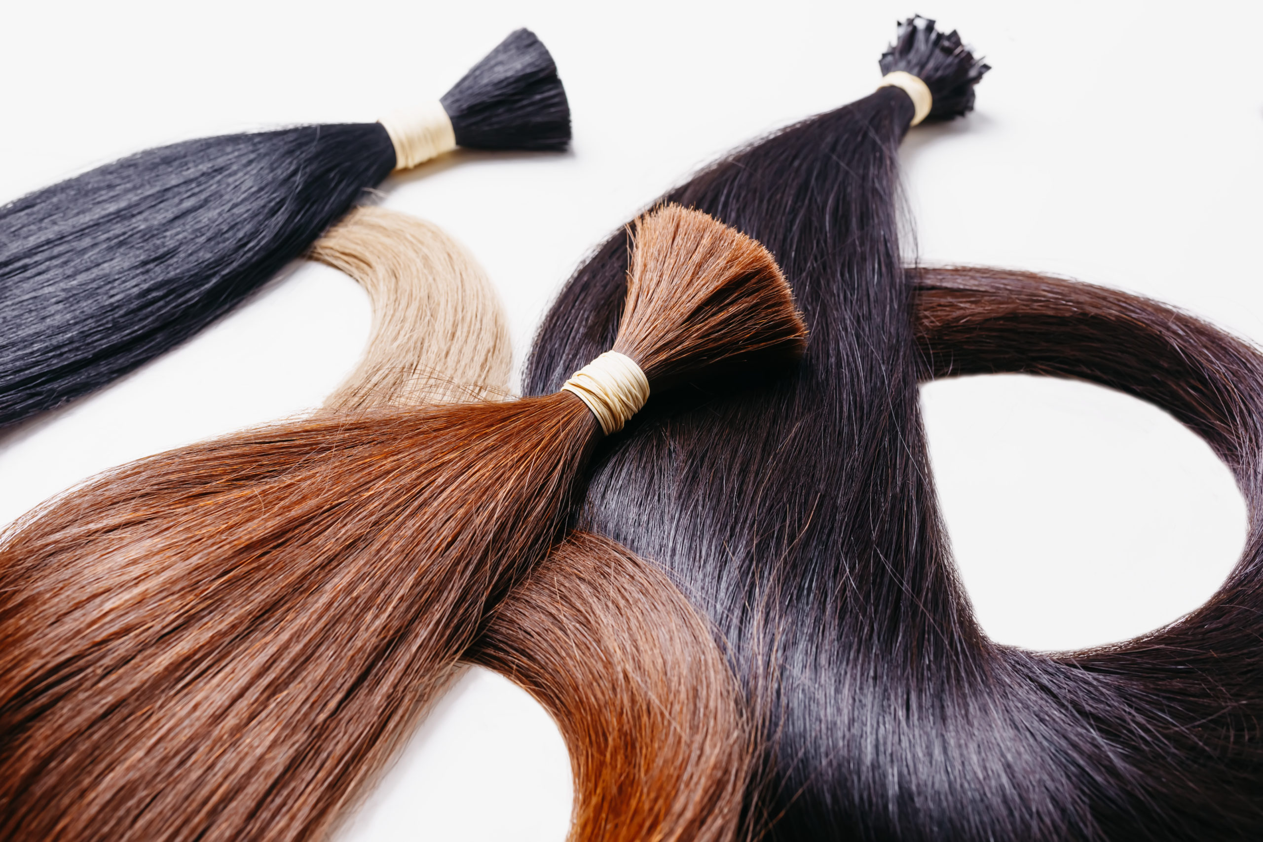 hair extensions of three colors on a white background
